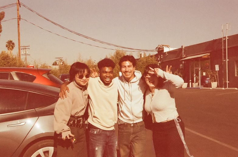 Friends posing together in a parking lot with vintage filter
