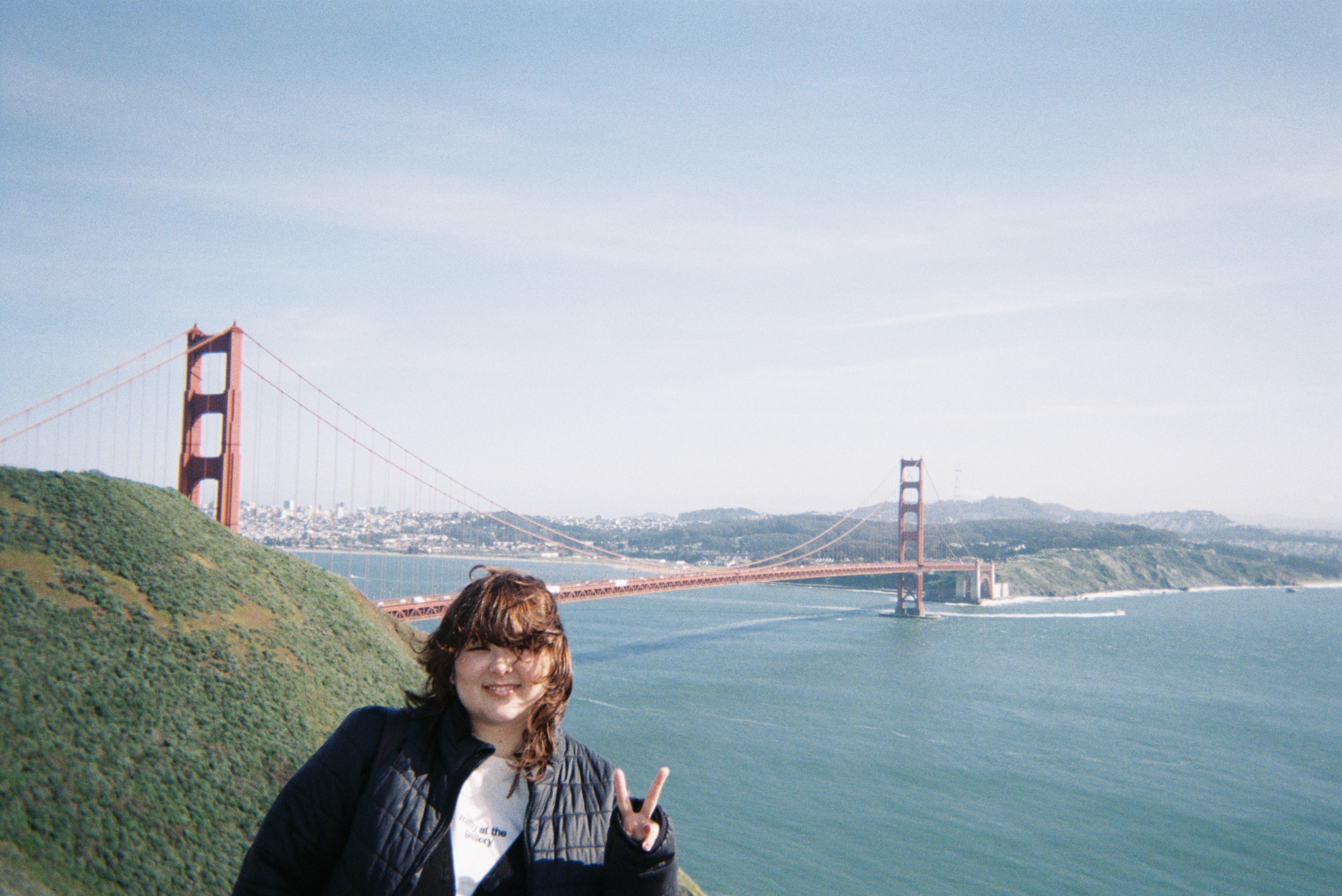 Person at Golden Gate Bridge in San Francisco making peace sign